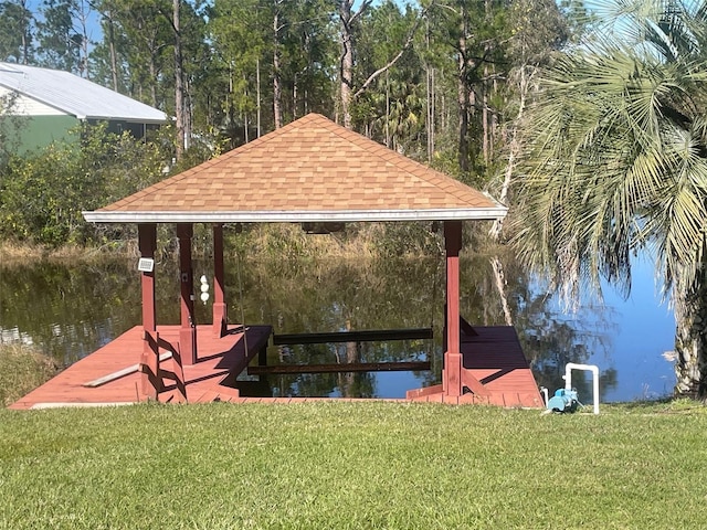 view of dock featuring a yard and a water view