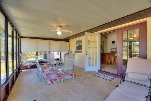 sunroom / solarium featuring ceiling fan and french doors