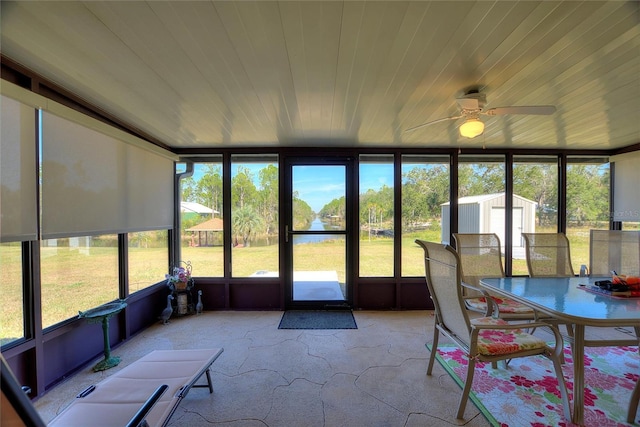 unfurnished sunroom featuring ceiling fan and wooden ceiling