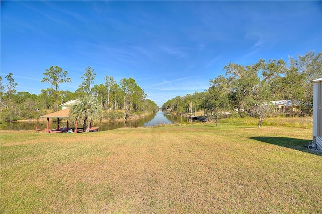 view of yard featuring a gazebo and a water view