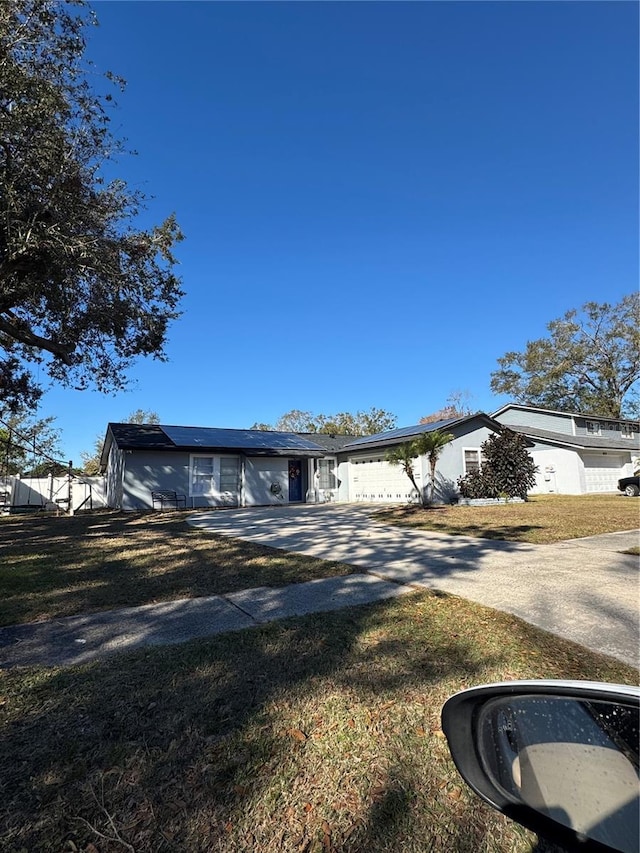 single story home featuring a front yard and a garage