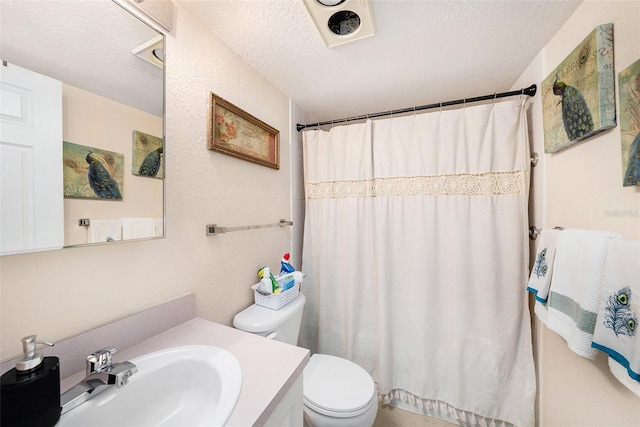 bathroom featuring toilet, a textured ceiling, a shower with shower curtain, and vanity