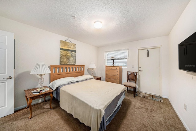 bedroom with a textured ceiling and carpet