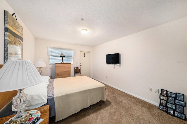 bedroom featuring a textured ceiling and carpet flooring