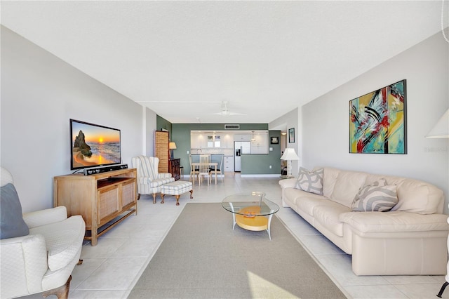 living room featuring light tile patterned flooring and ceiling fan