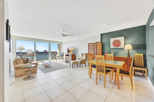 dining room featuring floor to ceiling windows, light tile patterned floors, a textured ceiling, and ceiling fan