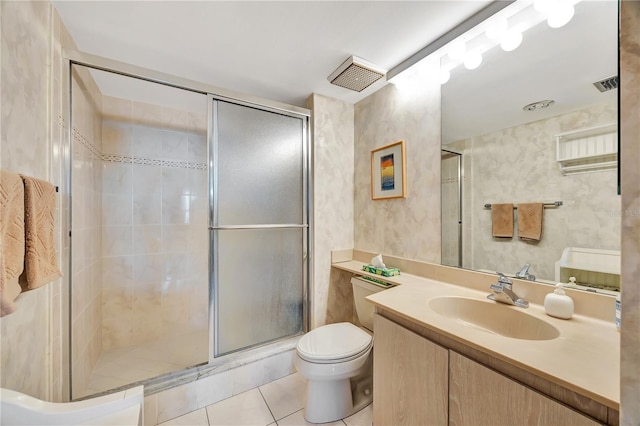 bathroom with tile patterned flooring, vanity, toilet, and walk in shower