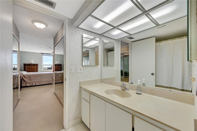 bathroom with vanity and a textured ceiling