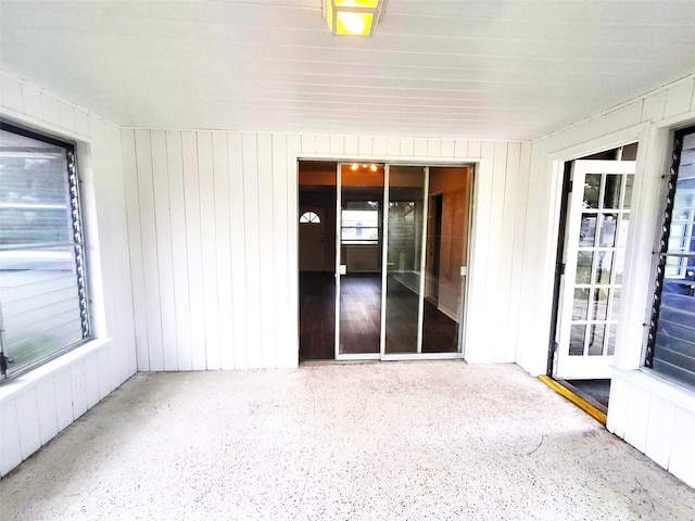 unfurnished room with wooden walls