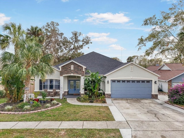 view of front of home with a front yard, french doors, and a garage