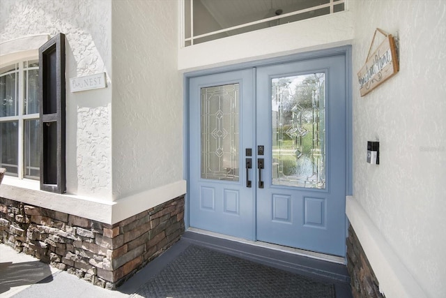 view of exterior entry featuring french doors