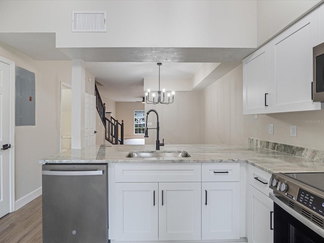 kitchen with stainless steel appliances, sink, and white cabinets