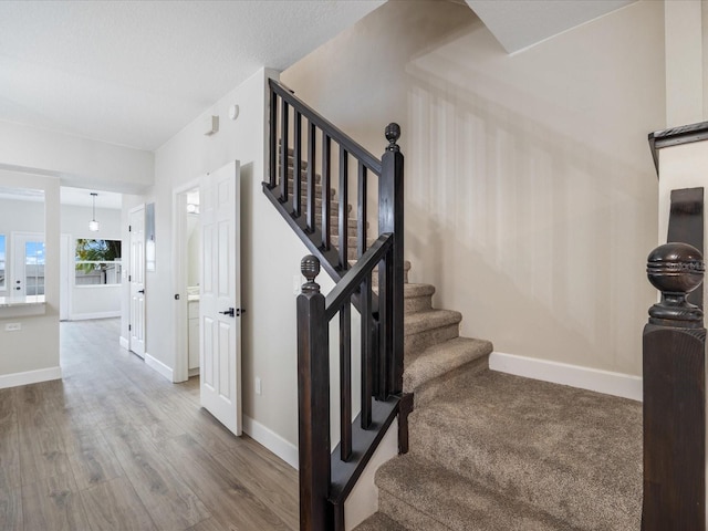 staircase with hardwood / wood-style flooring