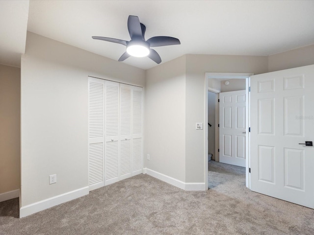 unfurnished bedroom featuring ceiling fan, light carpet, and a closet