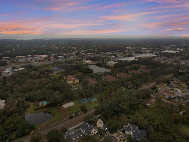 aerial view at dusk with a water view