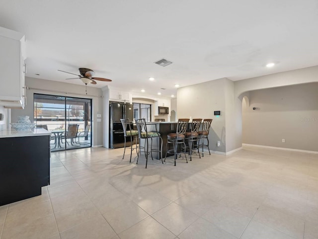 tiled dining space featuring ceiling fan