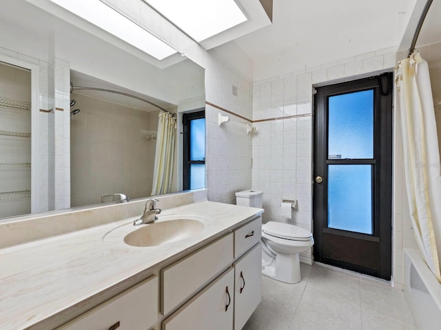 full bathroom with shower / bathtub combination with curtain, tile patterned flooring, vanity, tile walls, and toilet