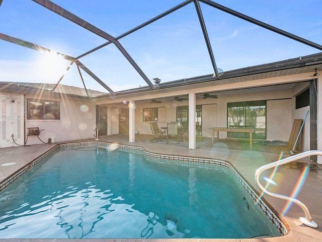 view of pool featuring a lanai, a patio, and ceiling fan