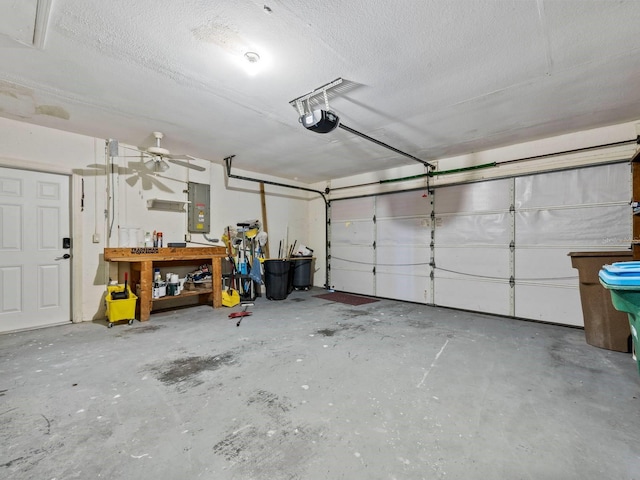 garage featuring electric panel and a garage door opener