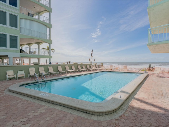 view of swimming pool with a water view