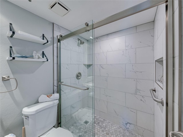 bathroom featuring toilet and walk in shower