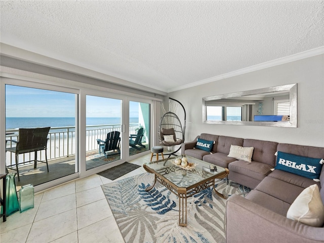 tiled living room with a textured ceiling, ornamental molding, and a water view