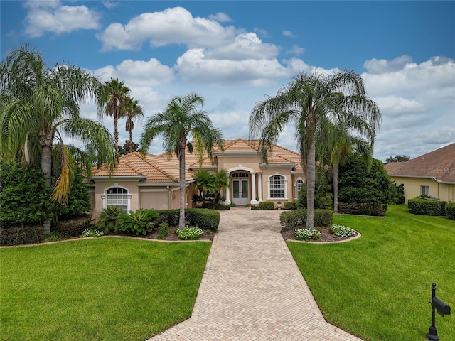 mediterranean / spanish house featuring a front lawn