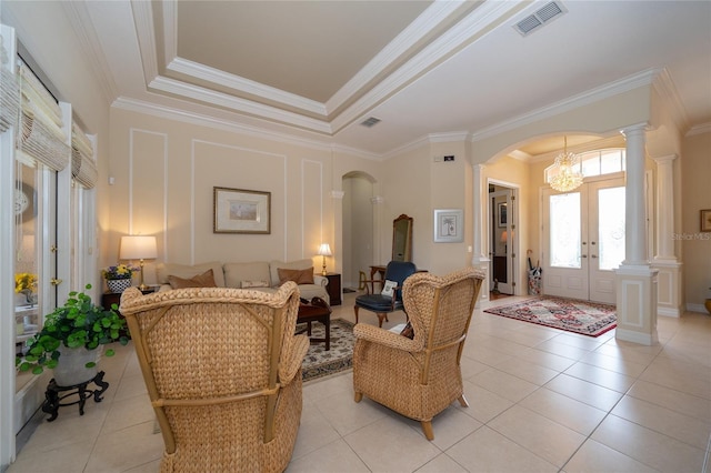 interior space featuring light tile patterned floors, ornamental molding, and ornate columns