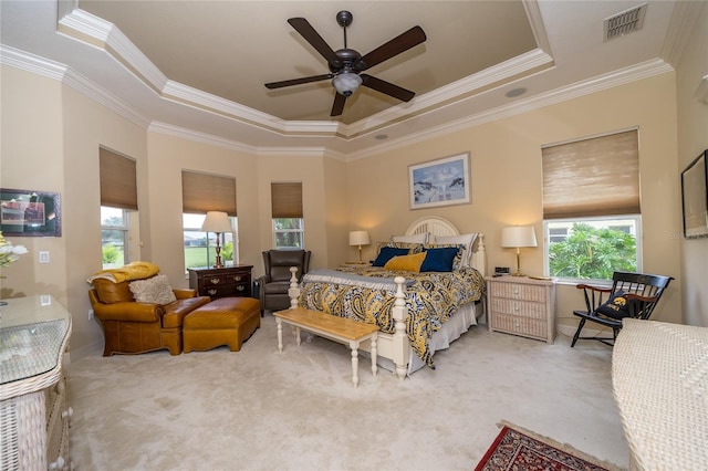 bedroom featuring ceiling fan, carpet flooring, crown molding, and a raised ceiling