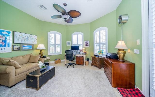 carpeted office featuring ceiling fan