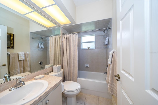 full bathroom featuring shower / bath combo with shower curtain, tile patterned floors, vanity, and toilet