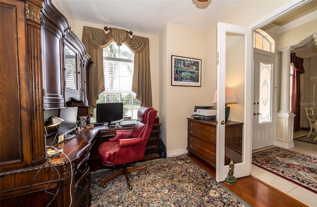 home office featuring decorative columns, wood-type flooring, and ornamental molding