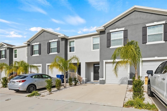 townhome / multi-family property featuring a garage