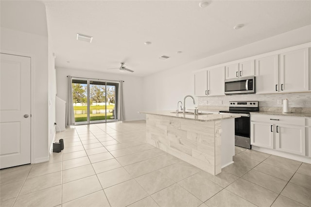 kitchen featuring light stone countertops, sink, white cabinets, and stainless steel appliances