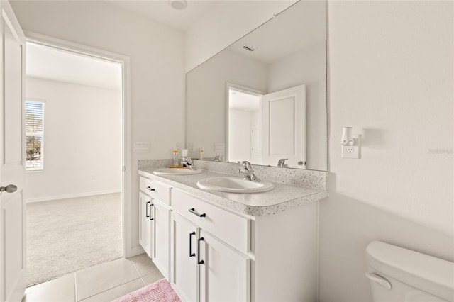 bathroom featuring vanity, toilet, and tile patterned floors