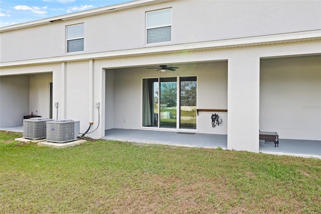 back of house with a patio area, central AC, and a yard