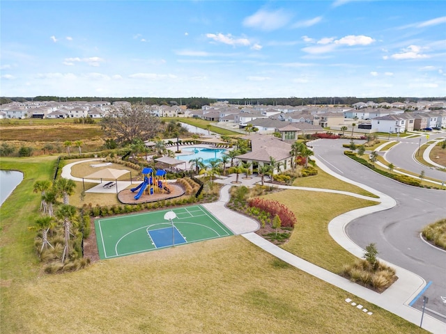 view of basketball court with a playground and a lawn