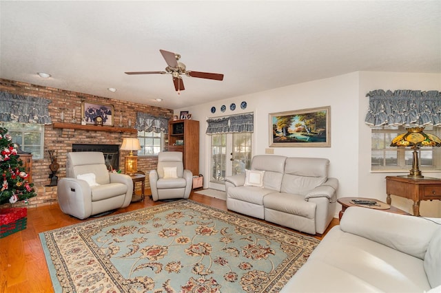 7312 7th Ave NW, Bradenton, FL 34209 - living area featuring ceiling fan, wood finished floors, a fireplace, and brick wall