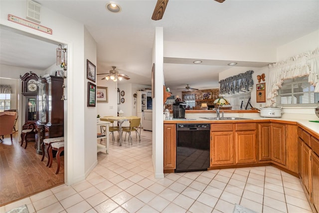 7312 7th Ave NW, Bradenton, FL 34209 - kitchen with black dishwasher, a ceiling fan, a sink, light countertops, and brown cabinetry