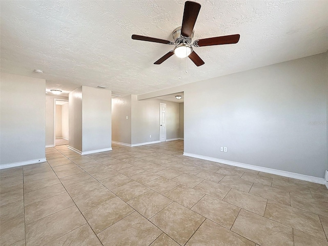 tiled empty room with ceiling fan and a textured ceiling