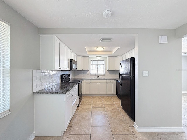 kitchen with tasteful backsplash, black appliances, sink, light tile patterned floors, and white cabinets