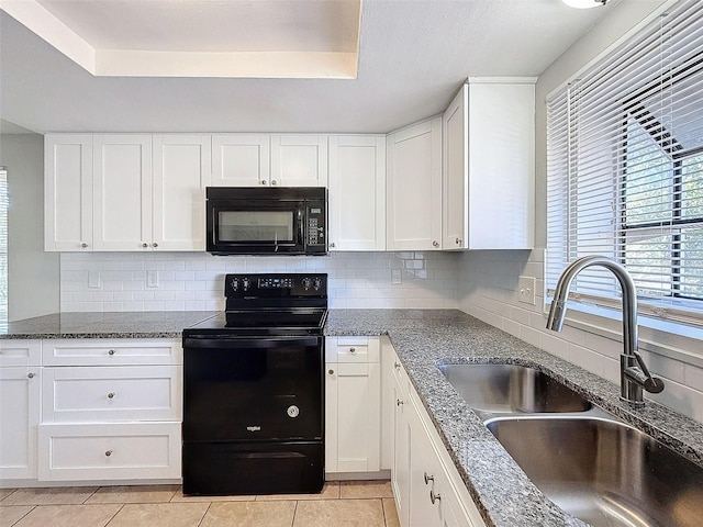 kitchen with sink, white cabinets, black appliances, and a raised ceiling