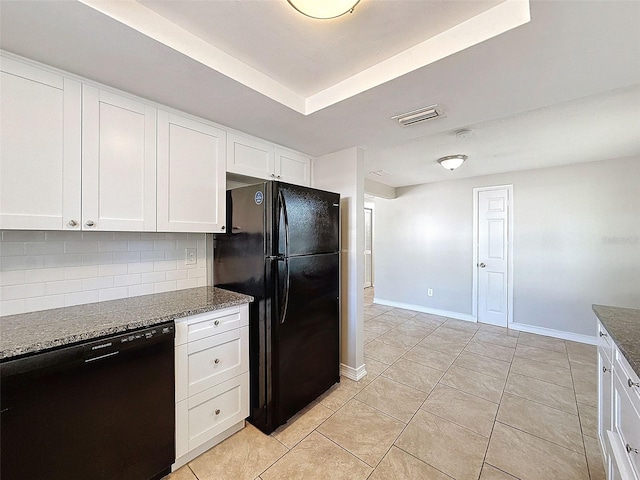 kitchen featuring black appliances, white cabinetry, dark stone countertops, backsplash, and light tile patterned floors