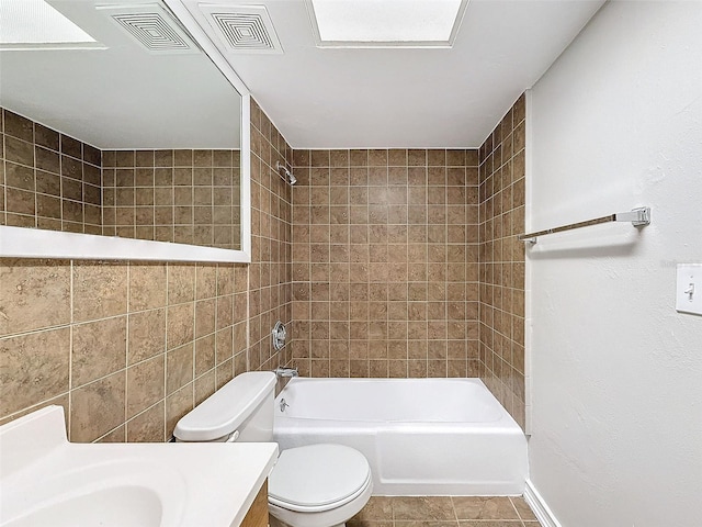 full bathroom with toilet, tiled shower / bath, and vanity