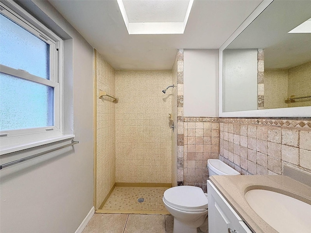 bathroom with toilet, a tile shower, tile walls, and tile patterned floors