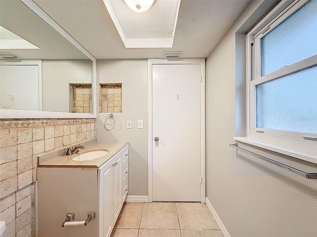 bathroom featuring tasteful backsplash, vanity, and tile patterned floors