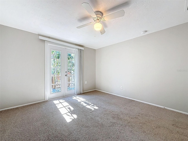 spare room with a textured ceiling, ceiling fan, carpet flooring, and french doors