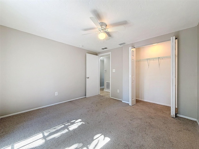 unfurnished bedroom with light carpet, a closet, and ceiling fan