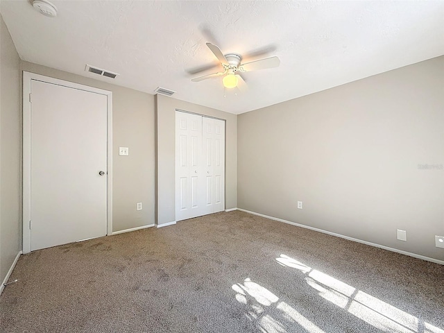 unfurnished bedroom featuring ceiling fan and carpet floors