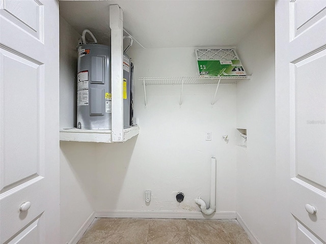 clothes washing area with water heater, hookup for a washing machine, and gas dryer hookup